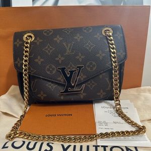 The compact Passy handbag in Monogram canvas with a sliding chain.